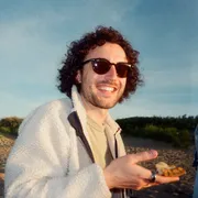 Will, holding a slice of pizza